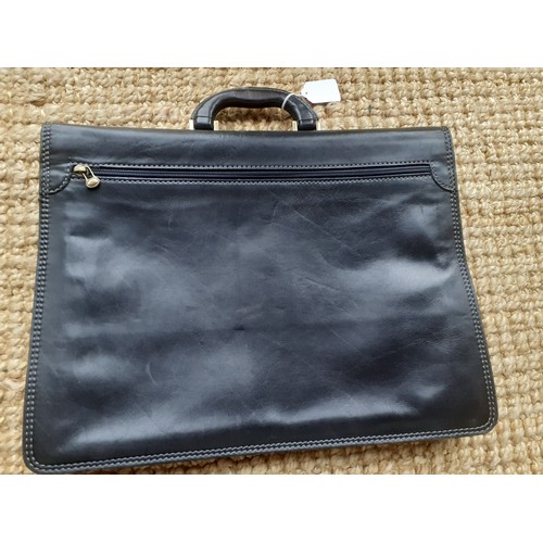 206 - The Bridge- A large black folio style briefcase with brushed brass hardware. Location: R1.1
If there... 