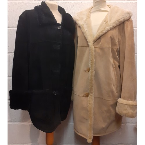 207 - Dennis Basso- Two ladies sheepskin coats comprising a black example (2 front buttons missing) size X... 