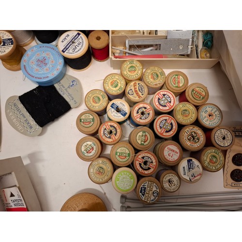 90 - A quantity of vintage sewing related items to include vintage cotton reels, sewing pattens, buttons,... 