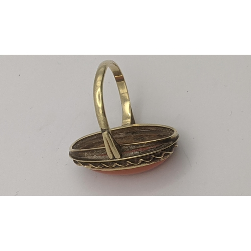 156 - A yellow metal and coral cabochon dress ring tested as 14ct yellow gold in oval form, total weight 4... 