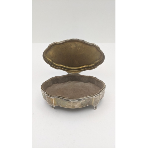 176 - A silver oval shaped ring box on four feet, hallmarked Birmingham 1944
Location: BWR 
If there is no... 