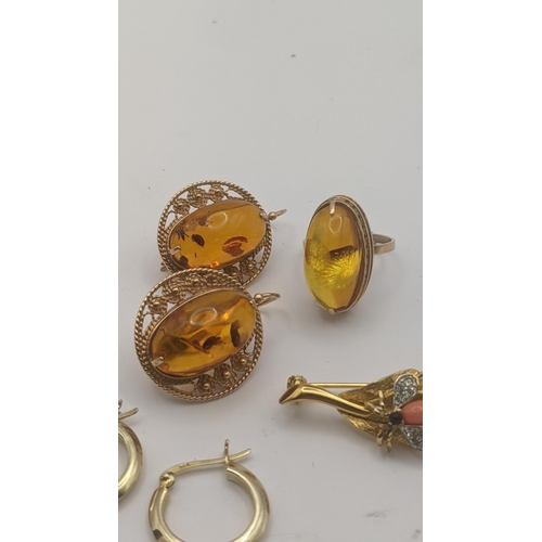 184 - A 14ct rose gold and amber style three piece set to include a ring set with amber style cabochon, an... 