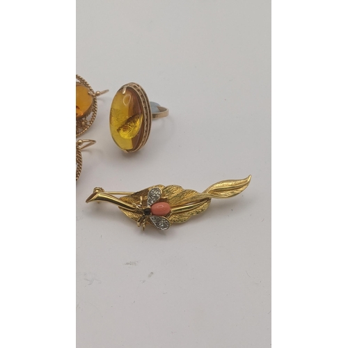 184 - A 14ct rose gold and amber style three piece set to include a ring set with amber style cabochon, an... 