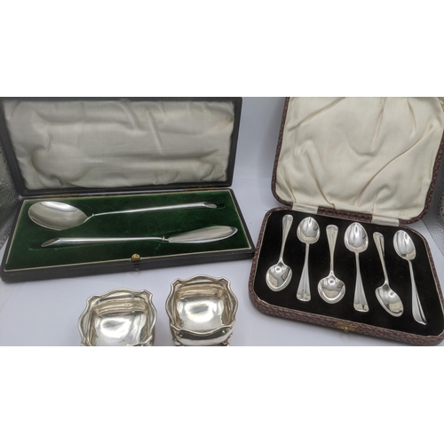 186 - Silver to incude a pair of salts one four feet, a christening set, along with a set of six silver te... 