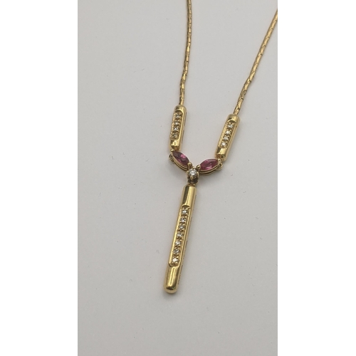 192 - A 9ct yellow gold necklace with a 9ct yellow ruby and diamond pendant set with a central brilliant c... 