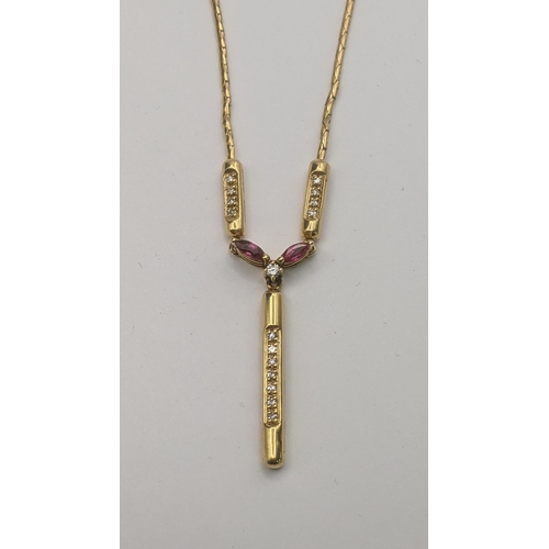 192 - A 9ct yellow gold necklace with a 9ct yellow ruby and diamond pendant set with a central brilliant c... 