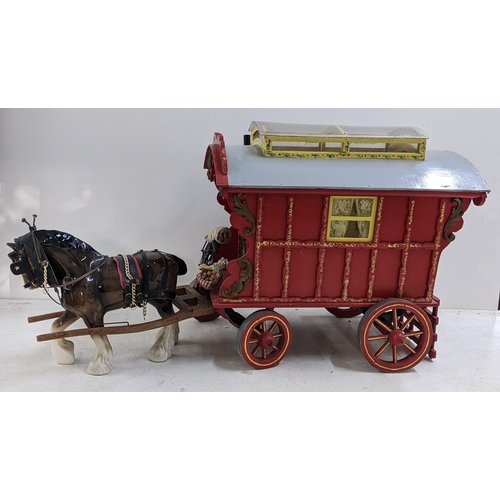 208 - A painted gypsy caravan model complete with contents and porcelain model of a horse, the caravan 39c... 