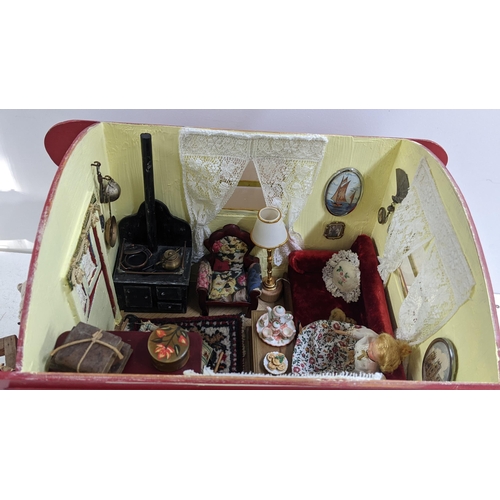 208 - A painted gypsy caravan model complete with contents and porcelain model of a horse, the caravan 39c... 