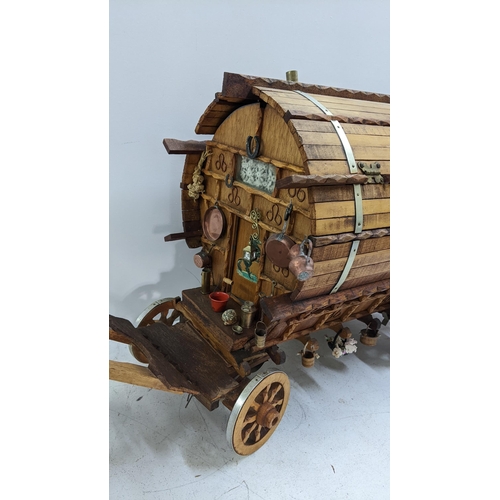 209 - A gypsy caravan model complete with contents and porcelain model of a horse, the caravan 39cm h x 42... 