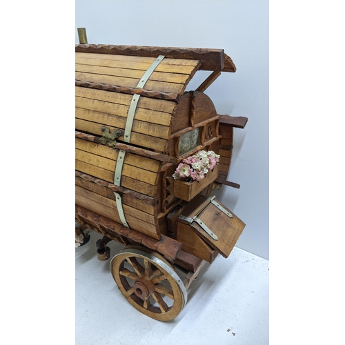 209 - A gypsy caravan model complete with contents and porcelain model of a horse, the caravan 39cm h x 42... 