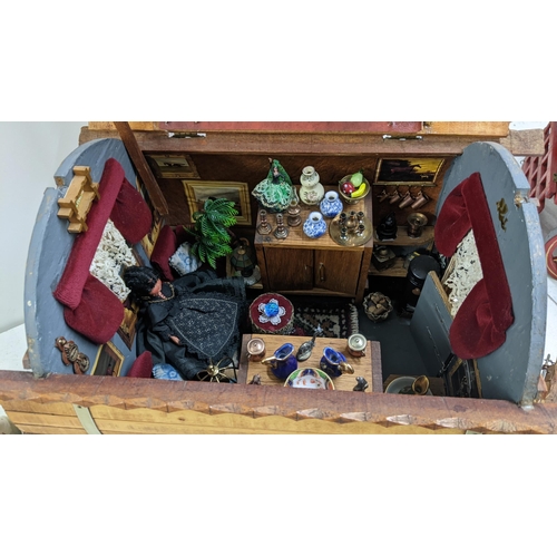 209 - A gypsy caravan model complete with contents and porcelain model of a horse, the caravan 39cm h x 42... 