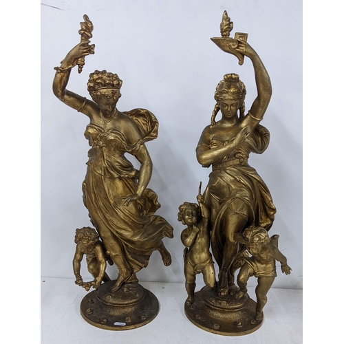 210 - Two Victorian gilded spelter figures of a maiden holding a torch above her head with cupid below, ta... 