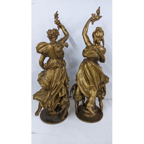 210 - Two Victorian gilded spelter figures of a maiden holding a torch above her head with cupid below, ta... 