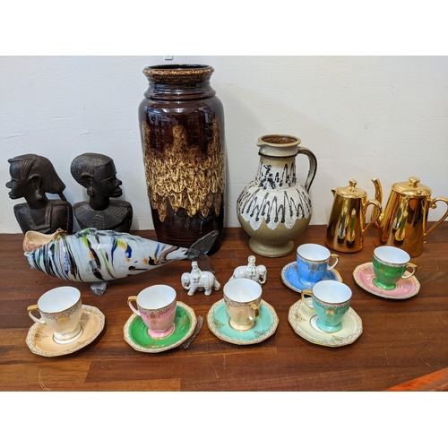 381 - Ceramics and glassware to include a West German vase, an end of day glass model fish, a pair of Afri... 