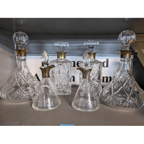 462 - A pair of silver collared and cut glass whisky decanters and a pair of matching ships decanters, alo... 