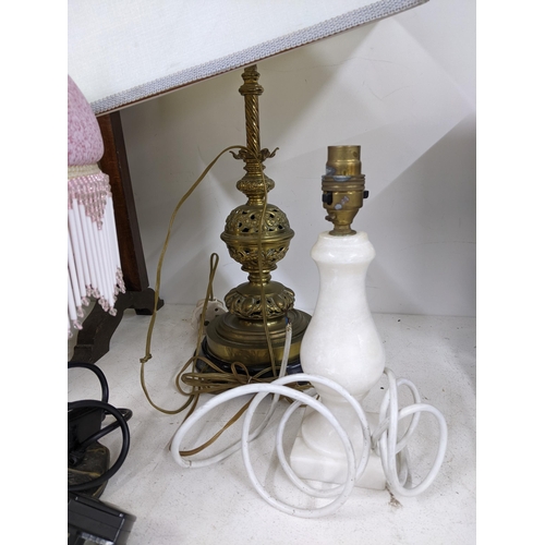 470 - A mixed lot to include four table lamps (three with shades), two strut clocks, Aladdin paraffin heat... 