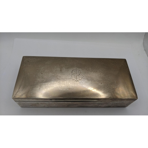 132 - An Goldsmiths and Silversmiths company silver cigarette box having engraved initials to the lid, hal... 