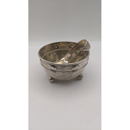 136 - An Arts & Crafts A.E. Jones silver sugar bowl on four ball feet with hammered design, and a pair of ... 