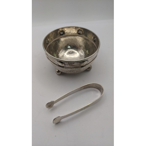 136 - An Arts & Crafts A.E. Jones silver sugar bowl on four ball feet with hammered design, and a pair of ... 