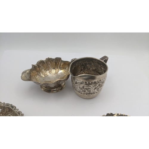 139 - Silver to include a cream jug, hallmarked London 1894 embossed floral design together with  one othe... 