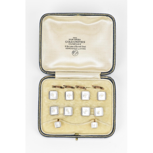 242 - A 9ct yellow and white gold dress shirt set, each having a seed pearl centre, mother of pearl and ma... 