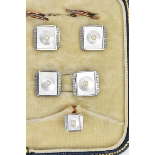 242 - A 9ct yellow and white gold dress shirt set, each having a seed pearl centre, mother of pearl and ma... 