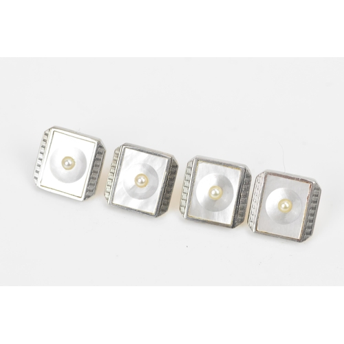 242 - A 9ct yellow and white gold dress shirt set, each having a seed pearl centre, mother of pearl and ma... 