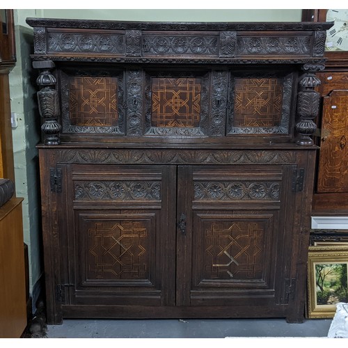 247 - A late 17th/early 18th century oak carved didarn / court cupboard, carved with repeating motifs, two... 