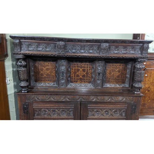 247 - A late 17th/early 18th century oak carved didarn / court cupboard, carved with repeating motifs, two... 