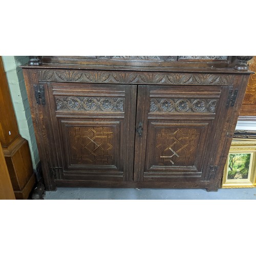 247 - A late 17th/early 18th century oak carved didarn / court cupboard, carved with repeating motifs, two... 