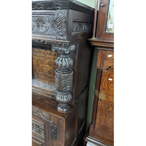 247 - A late 17th/early 18th century oak carved didarn / court cupboard, carved with repeating motifs, two... 