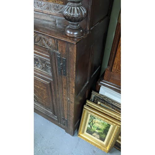 247 - A late 17th/early 18th century oak carved didarn / court cupboard, carved with repeating motifs, two... 