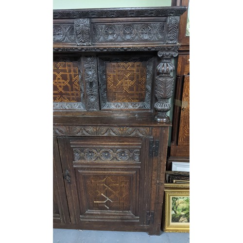 247 - A late 17th/early 18th century oak carved didarn / court cupboard, carved with repeating motifs, two... 