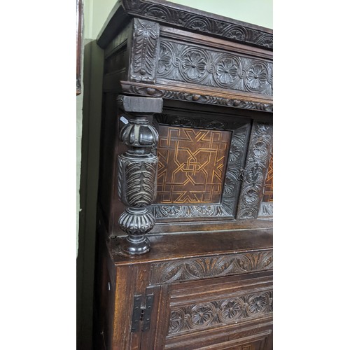 247 - A late 17th/early 18th century oak carved didarn / court cupboard, carved with repeating motifs, two... 