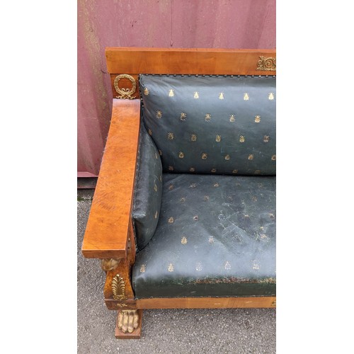 243 - An early 19th century Empire burr walnut and satinwood two seater sofa, applied gilt metal mounts in... 