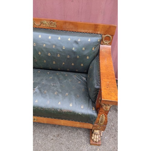 243 - An early 19th century Empire burr walnut and satinwood two seater sofa, applied gilt metal mounts in... 