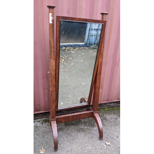 245 - A 19th century French empire cheval mirror, the swing mirror supported by two tapering columns and e... 