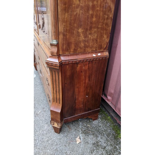 246 - An 18th century Dutch mahogany linen press, the cornice having repeated interlocking semi circle des... 