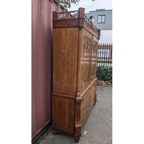 246 - An 18th century Dutch mahogany linen press, the cornice having repeated interlocking semi circle des... 