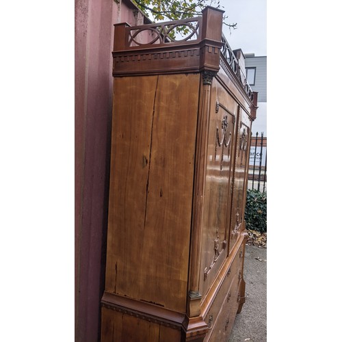 246 - An 18th century Dutch mahogany linen press, the cornice having repeated interlocking semi circle des... 