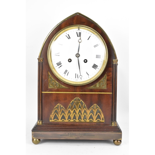 112 - An Edwardian mahogany mantle clock, Regency inspired with pierced gilt metal grilles, twin lion ring... 