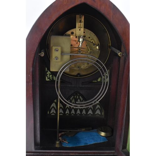 112 - An Edwardian mahogany mantle clock, Regency inspired with pierced gilt metal grilles, twin lion ring... 