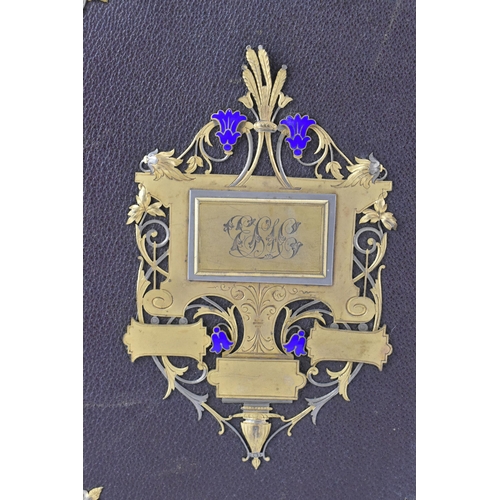 125 - Three photograph albums to include a Victorian leather bound example, the front cover applied with g... 