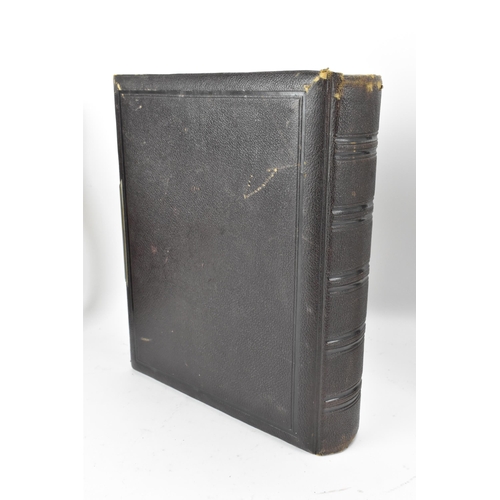 125 - Three photograph albums to include a Victorian leather bound example, the front cover applied with g... 