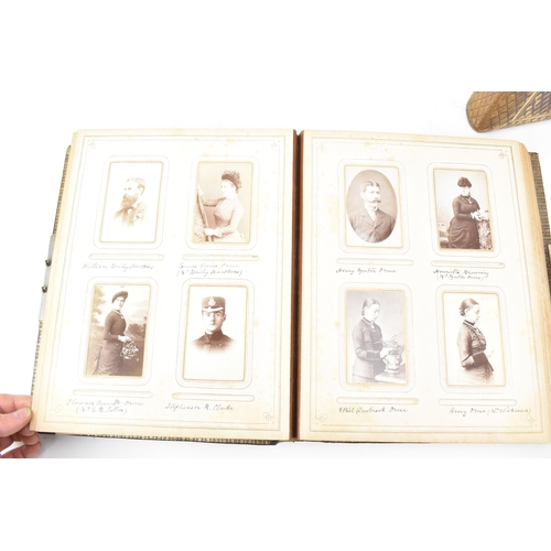 125 - Three photograph albums to include a Victorian leather bound example, the front cover applied with g... 