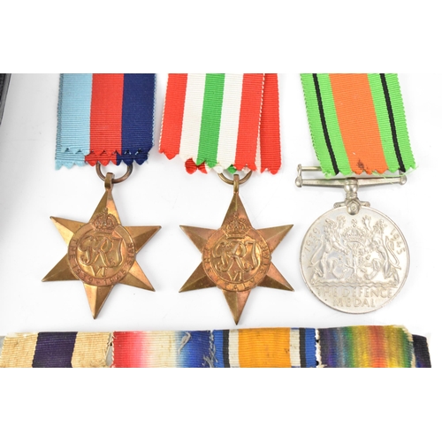 131 - A WWI and WWII medal group to include a cased military cross, 1914/15 star, War and Victory medal na... 