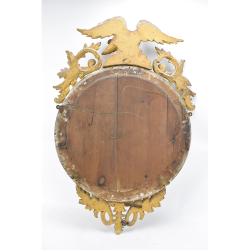 236 - A Regency wall mirror, having a convex plate in a gilt moulded and carved giltwood frame with a ball... 