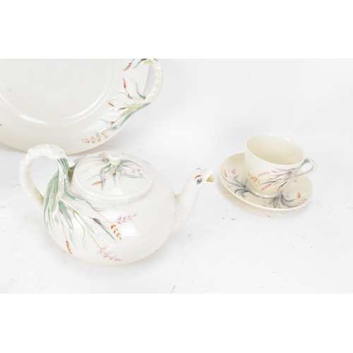 249 - A 19th century Belleek 1st period tea set, consisting of two tea pots, twin handled plate, four cups... 