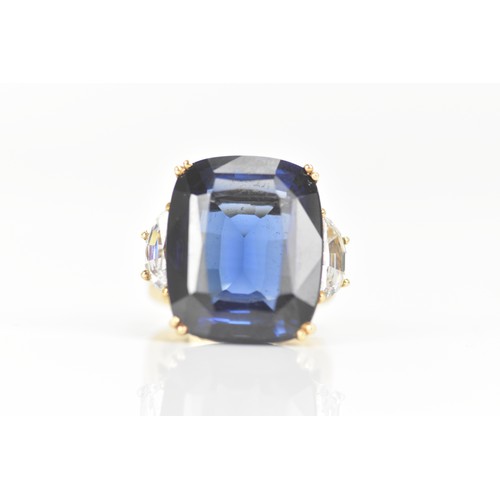 254 - A yellow gold dress ring, set with a large faceted cut blue coloured stone in a four claw setting, f... 