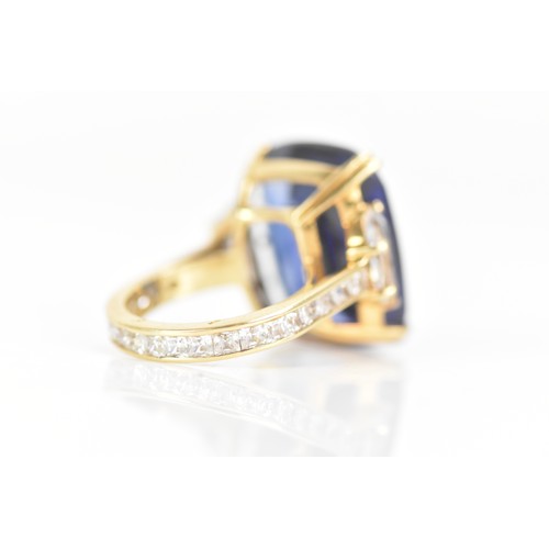 254 - A yellow gold dress ring, set with a large faceted cut blue coloured stone in a four claw setting, f... 